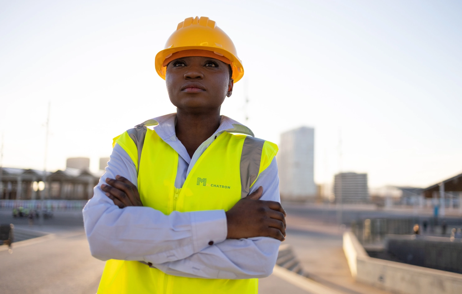 A staff member wearing a hard hat in an industrial setting